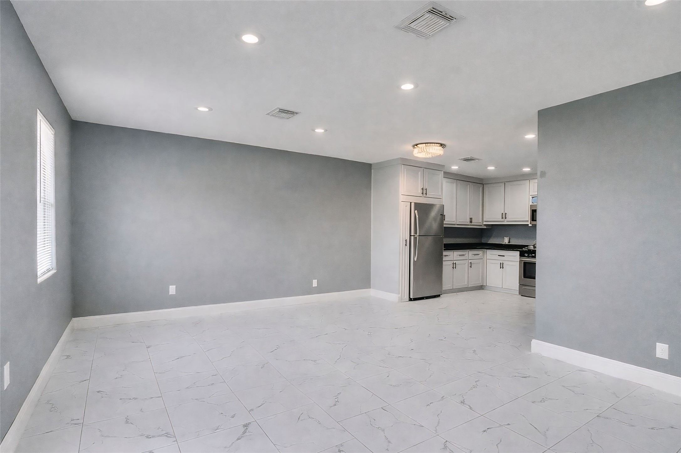 1107 East 40th 1/2 Street Houston, TX 77022 - Photo 13 of 15 a view of kitchen with kitchen island a sink stainless steel appliances and cabinets
