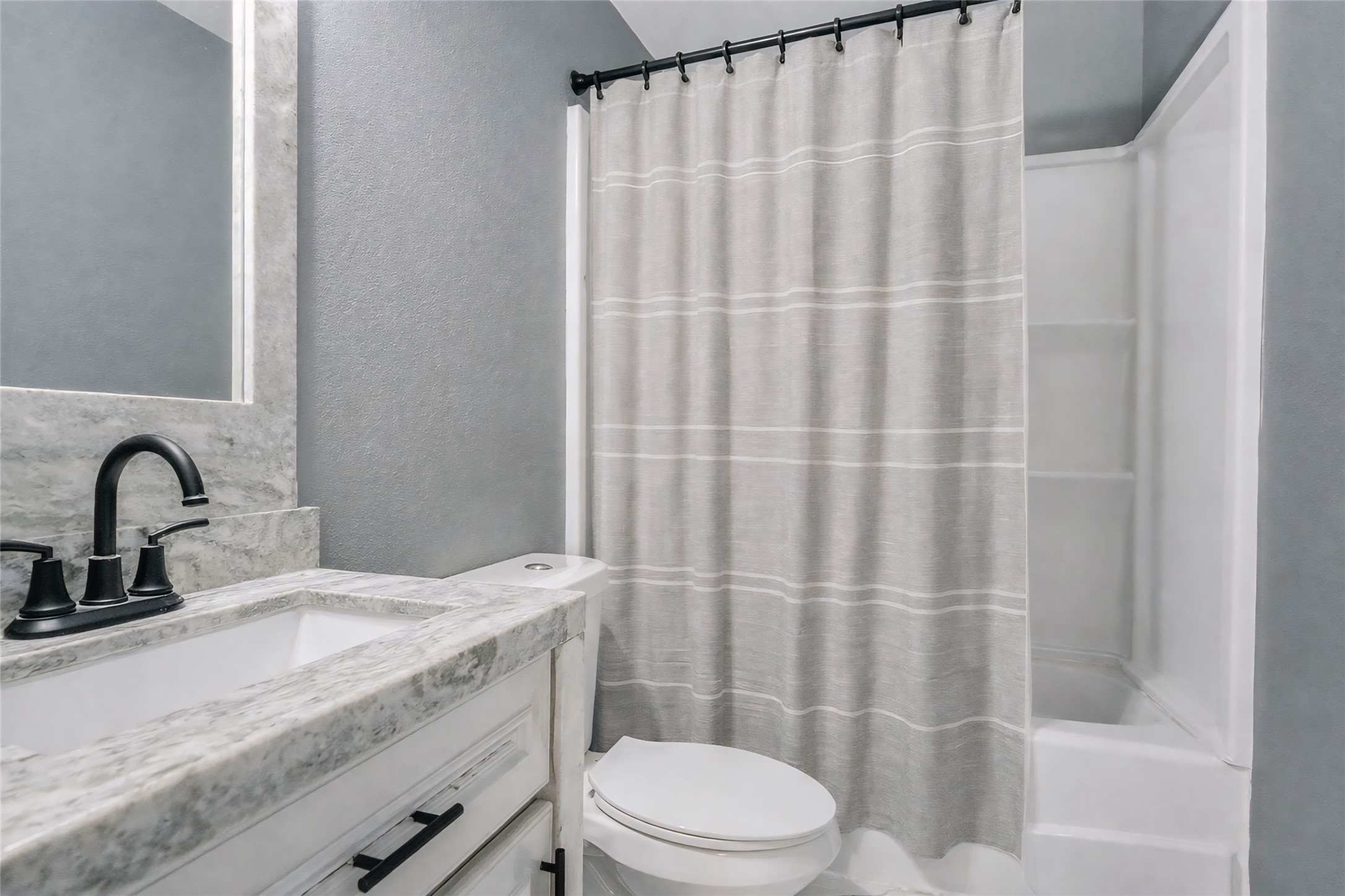 1107 East 40th 1/2 Street Houston, TX 77022 - Photo 15 of 15 a bathroom with a granite countertop sink and a mirror