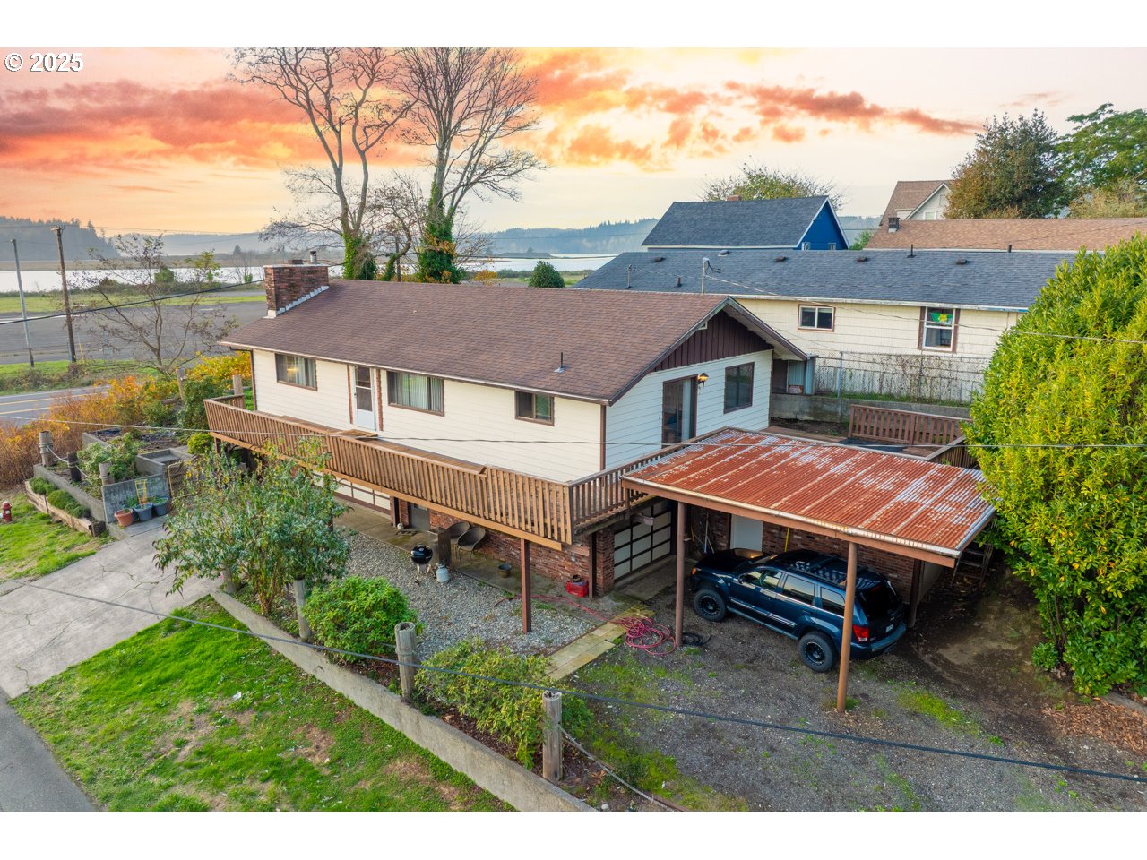 a aerial view of a house with a yard and sitting area