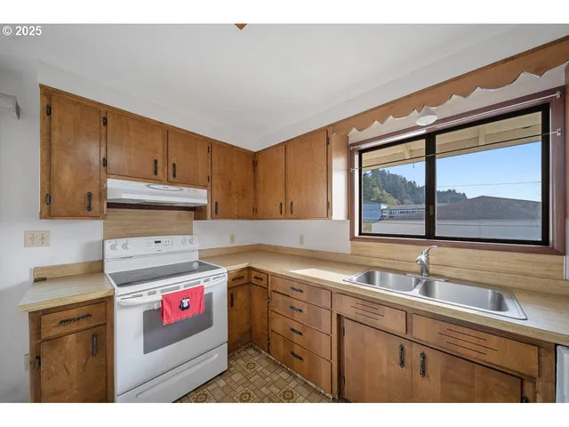 a kitchen with stainless steel appliances a refrigerator a stove and cabinets