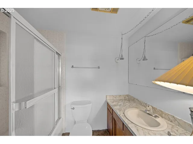 a kitchen with a refrigerator and cabinets