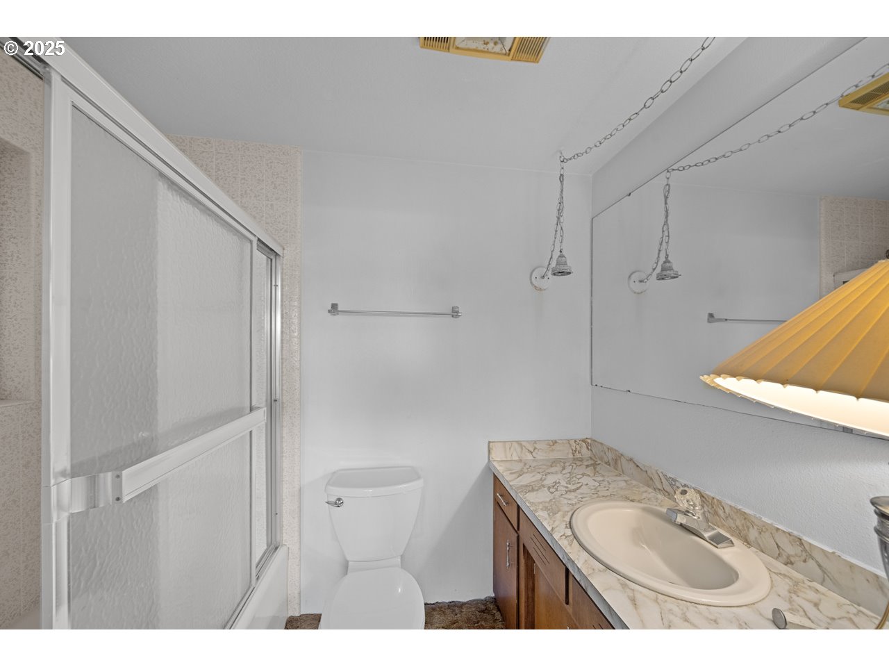 205 Marsh Street Gardiner, OR 97441 - Photo 31 of 46 a bathroom with a granite countertop sink a toilet and shower