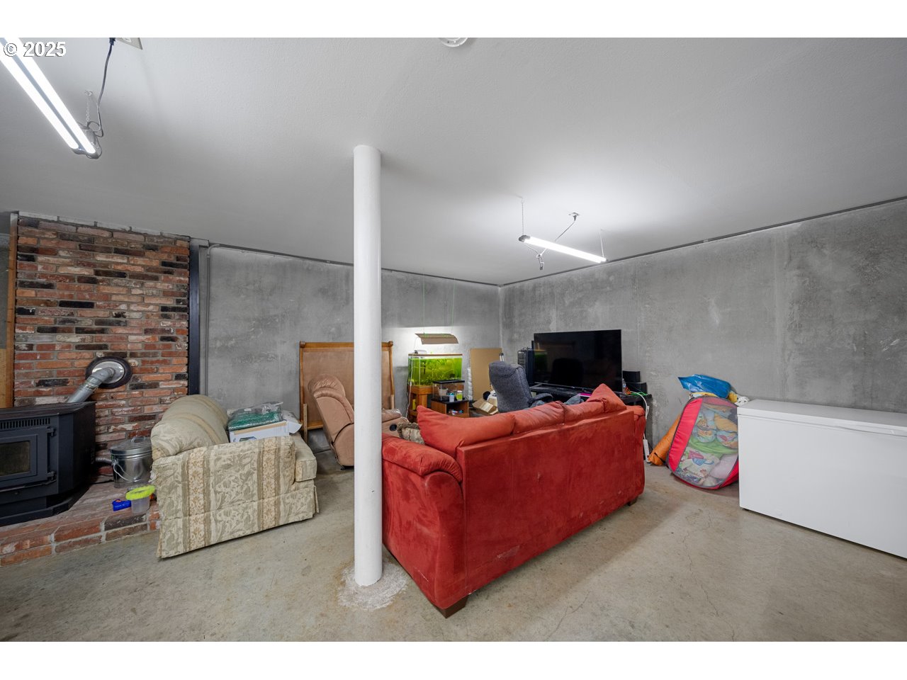 205 Marsh Street Gardiner, OR 97441 - Photo 41 of 46 a living room with furniture and a flat screen tv
