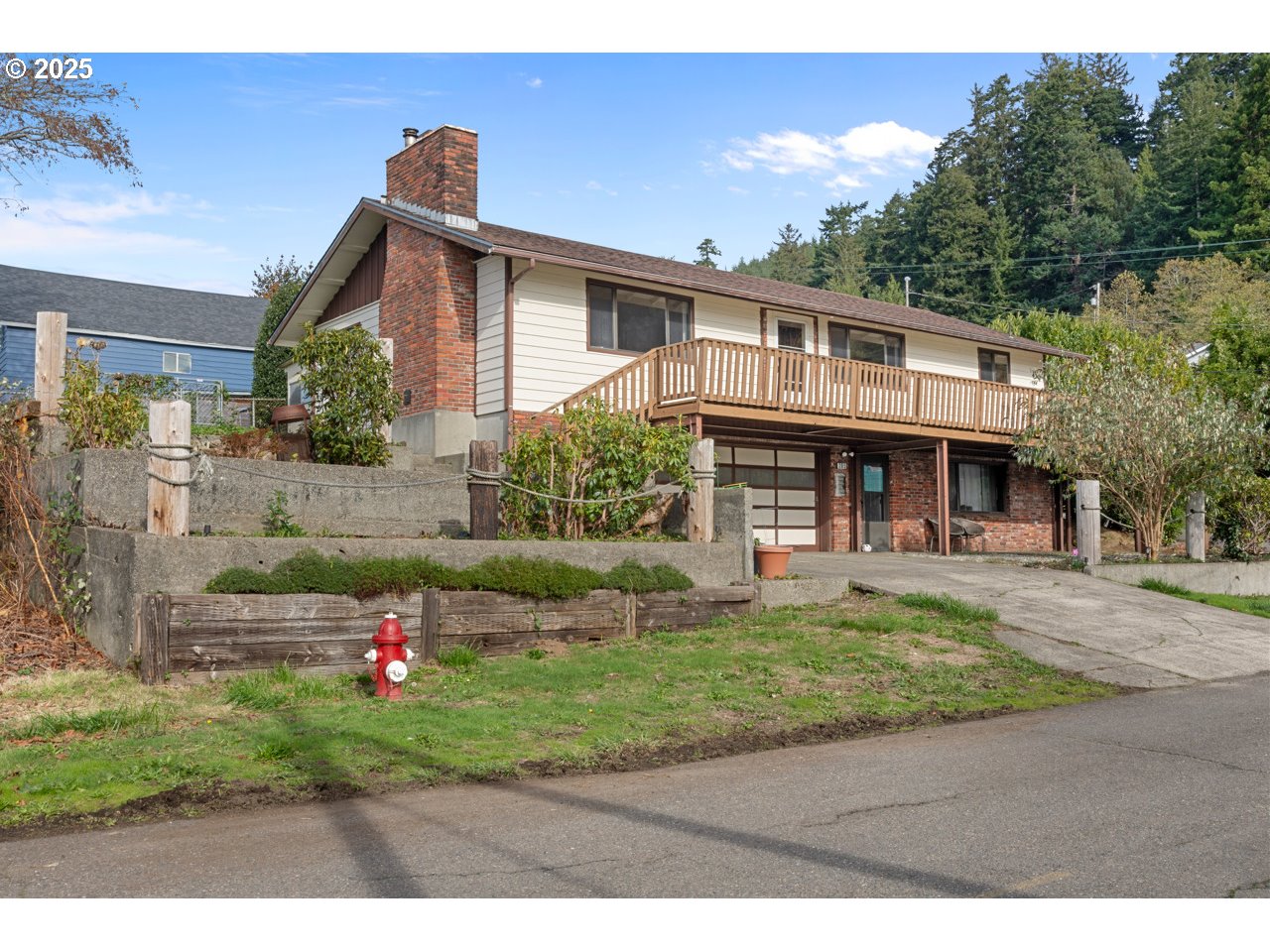 205 Marsh Street Gardiner, OR 97441 - Photo 9 of 46 a front view of a house with a yard table and chairs