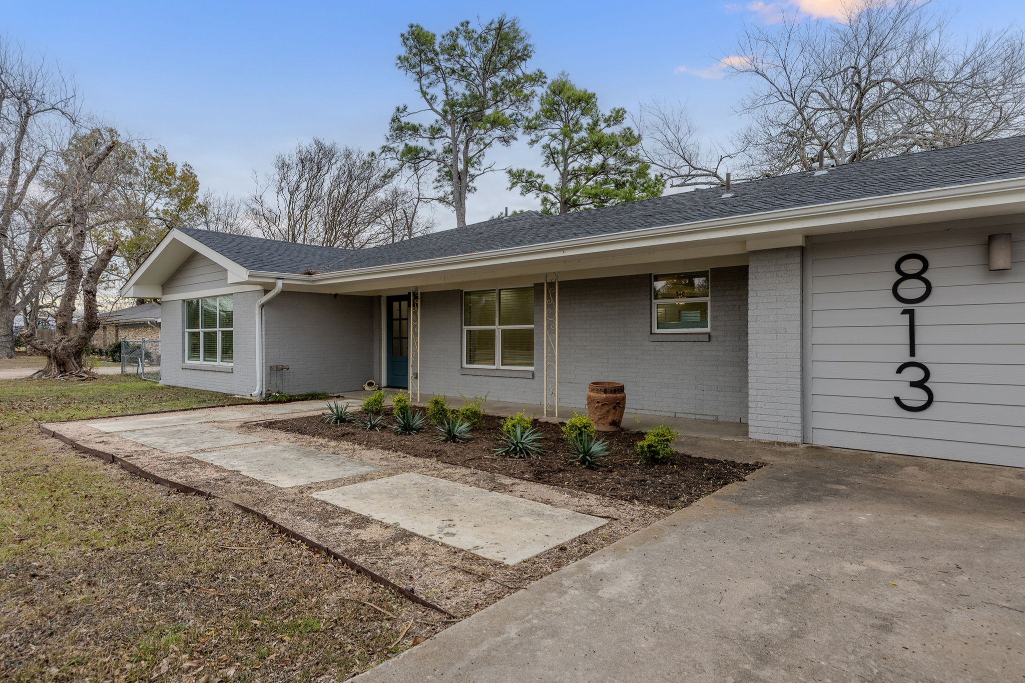 813 Central Avenue Elgin, TX 78621 - Photo 1 of 22 View of front of house with brick siding, roof with shingles, covered porch, and a front yard