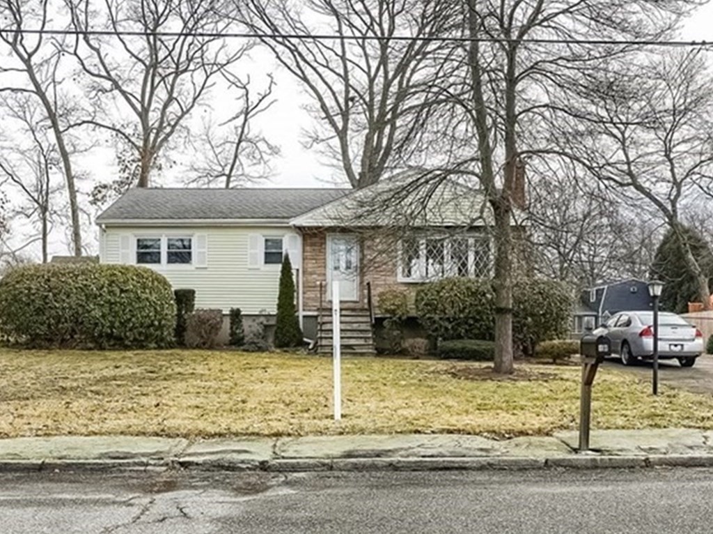 10 Sullivan Drive Randolph, MA 02368 - Photo 1 of 40 a house that has a tree in front of it