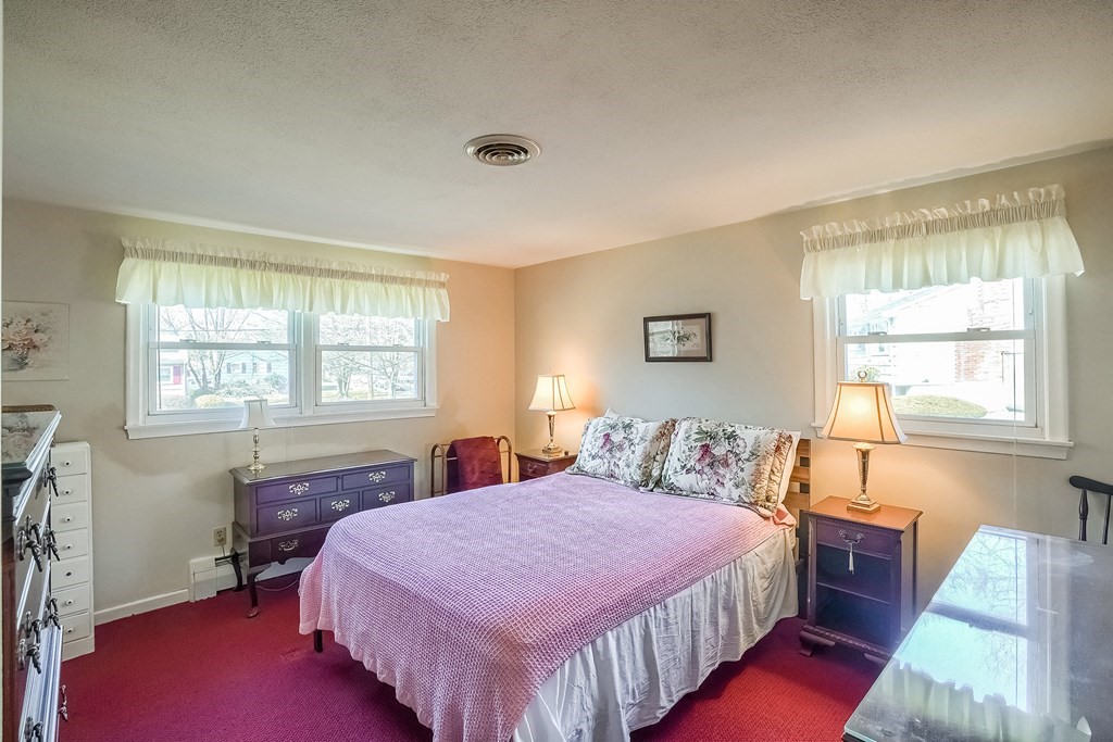 10 Sullivan Drive Randolph, MA 02368 - Photo 15 of 40 a bedroom with a bed and a window