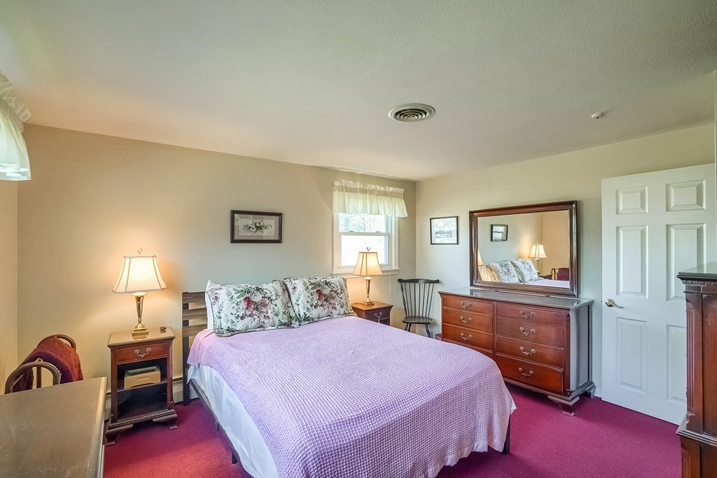 10 Sullivan Drive Randolph, MA 02368 - Photo 16 of 40 a bedroom with a bed and wooden floor