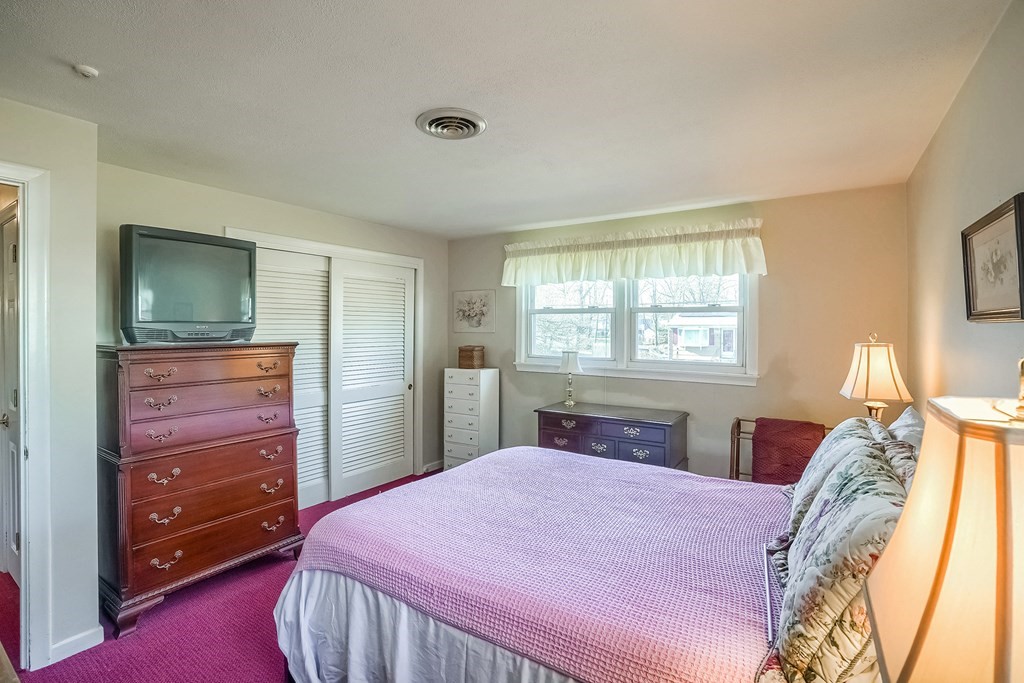 10 Sullivan Drive Randolph, MA 02368 - Photo 17 of 40 a bedroom with a bed and a dresser