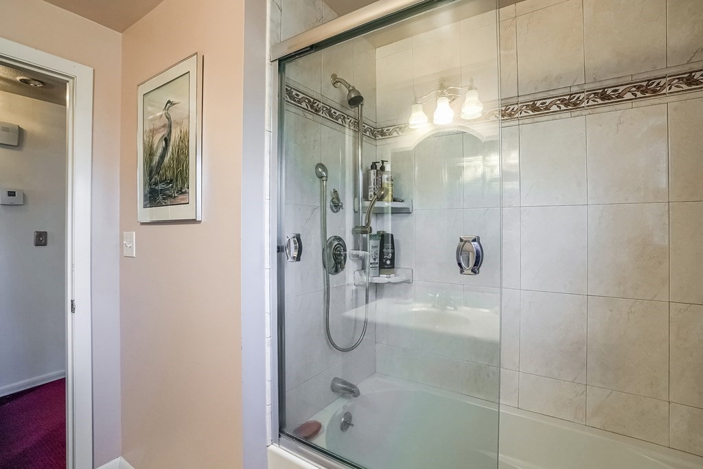 10 Sullivan Drive Randolph, MA 02368 - Photo 20 of 40 a bathroom with a glass shower door