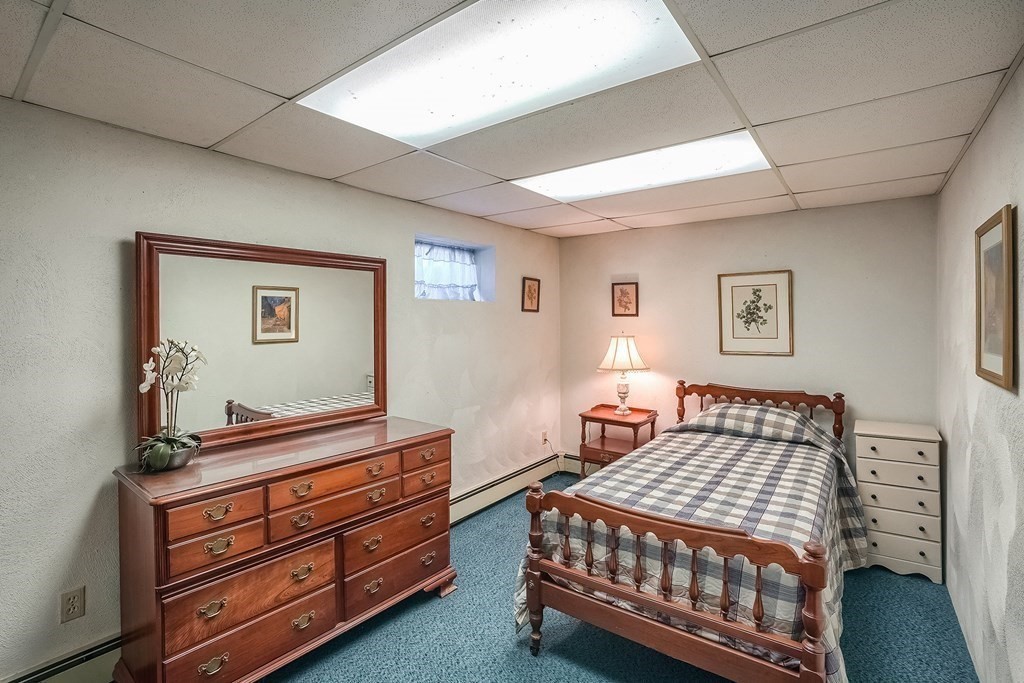 10 Sullivan Drive Randolph, MA 02368 - Photo 23 of 40 a bedroom with a bed and a dresser
