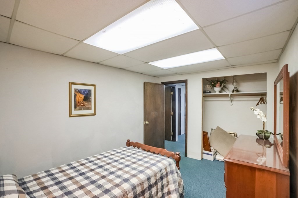 10 Sullivan Drive Randolph, MA 02368 - Photo 24 of 40 a bedroom with a bed and a couch