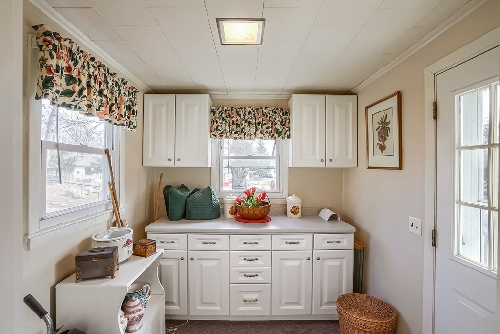 10 Sullivan Drive Randolph, MA 02368 - Photo 32 of 40 a kitchen with white cabinets and window