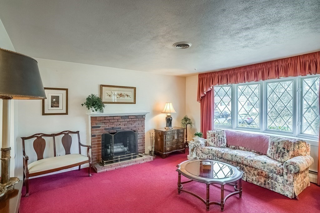 10 Sullivan Drive Randolph, MA 02368 - Photo 9 of 40 a living room with furniture and a fireplace