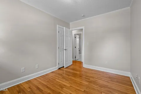 a view of a room with wooden floor