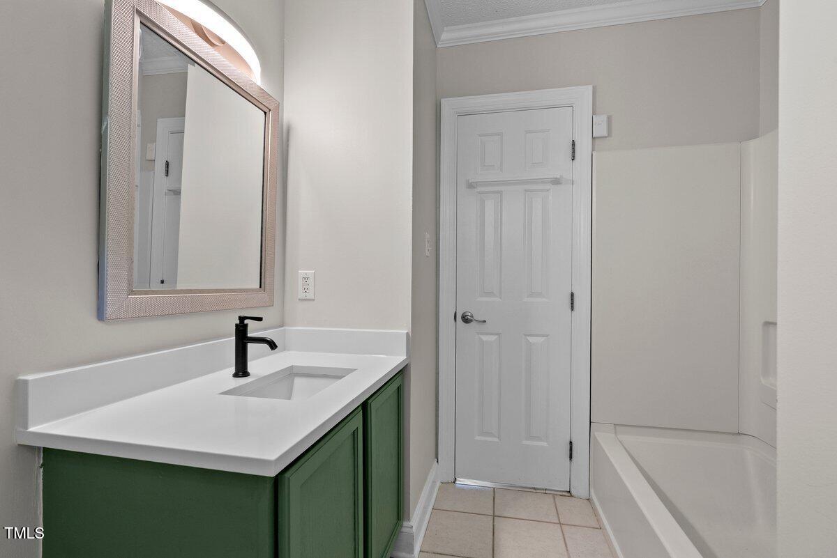 202 Purvis Street Garner, NC 27529 - Photo 17 of 28 a bathroom with a sink and a mirror