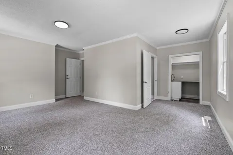 a view of empty room with a fireplace