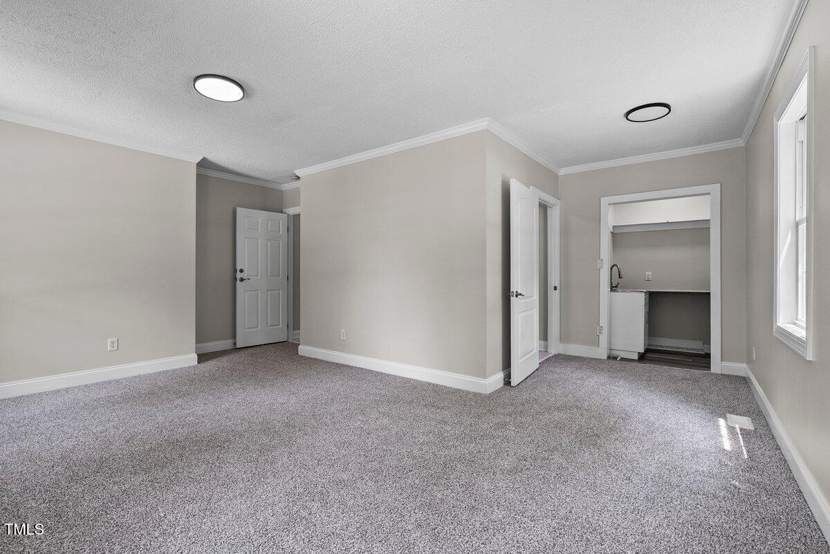 202 Purvis Street Garner, NC 27529 - Photo 20 of 28 a view of empty room with a fireplace