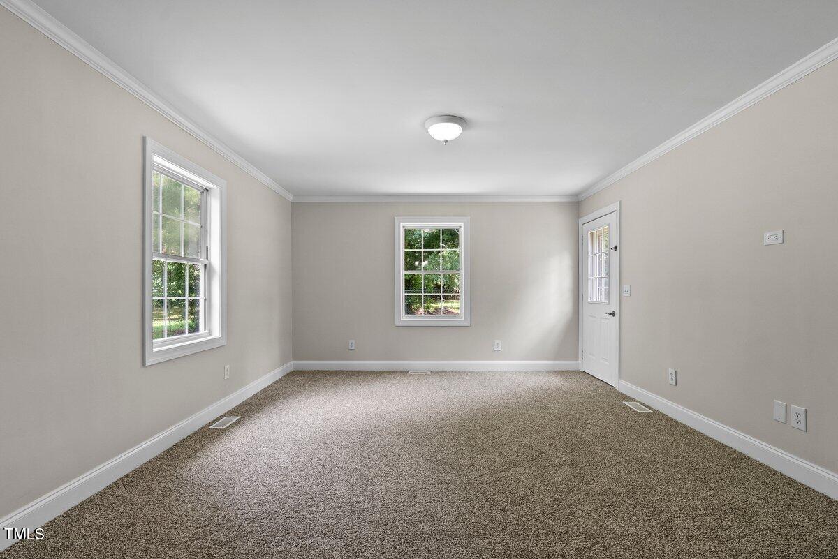 202 Purvis Street Garner, NC 27529 - Photo 6 of 28 an empty room with windows