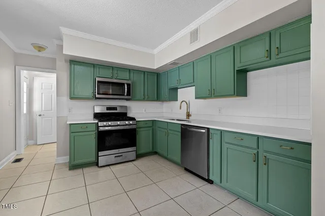 a kitchen with a sink a stove and cabinets