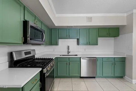 a kitchen with a stove sink and cabinets