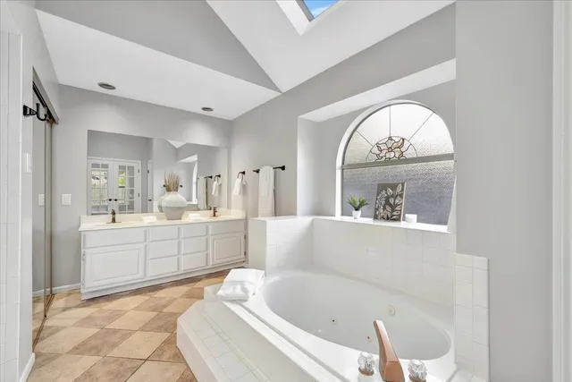 a large white tub sitting in a bathroom