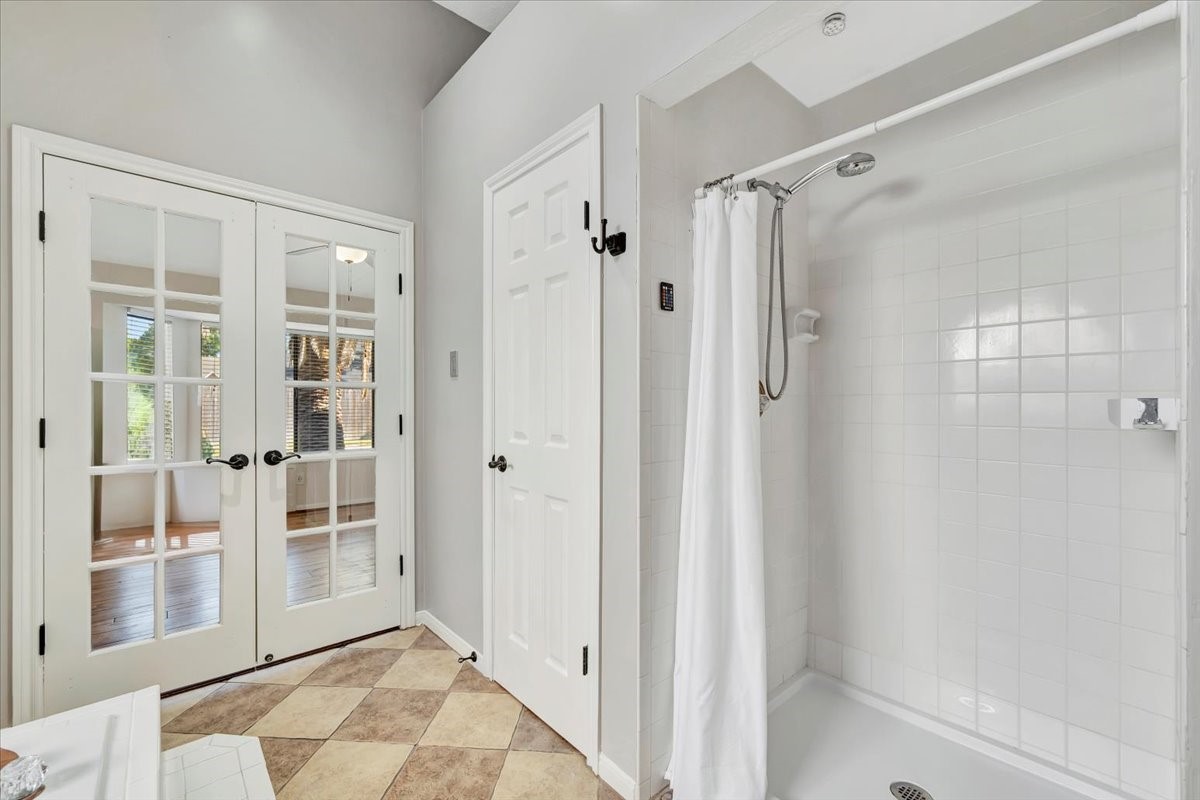 15131 Cranbourne Drive Houston, TX 77062 - Photo 21 of 42 a view of a bathroom with a glass door shower