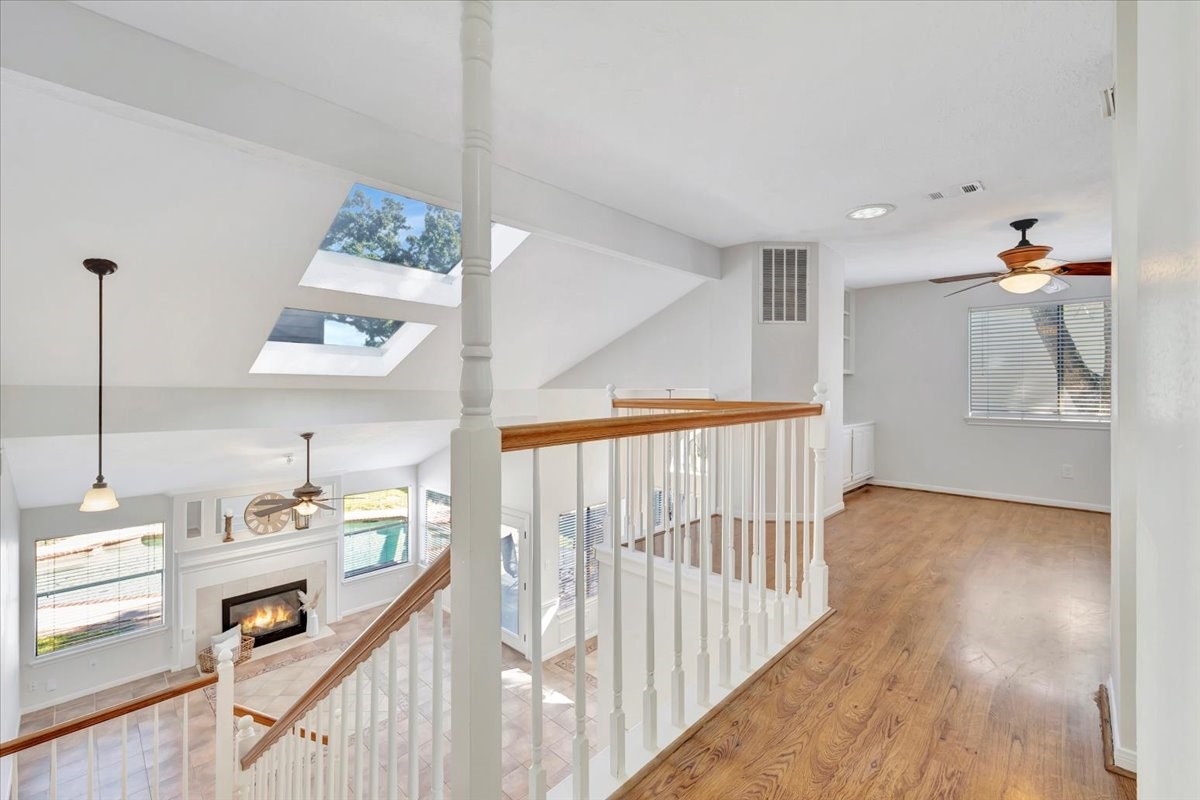15131 Cranbourne Drive Houston, TX 77062 - Photo 23 of 42 a view of a hallway to room with wooden floor