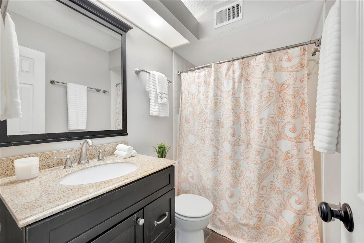15131 Cranbourne Drive Houston, TX 77062 - Photo 29 of 42 a bathroom with a granite countertop sink and a mirror