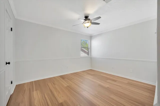 an empty room with a empty space and a ceiling fan