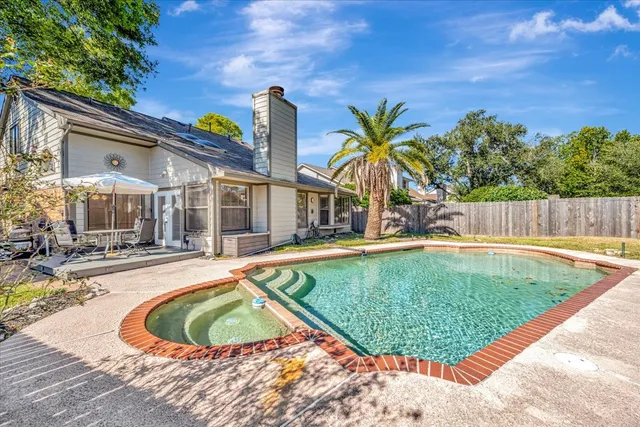 a view of a backyard with sitting area