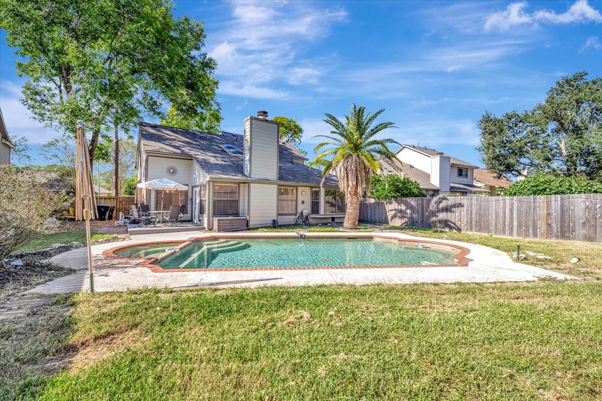 15131 Cranbourne Drive Houston, TX 77062 - Photo 35 of 42 a view of a house with swimming pool and next to a yard