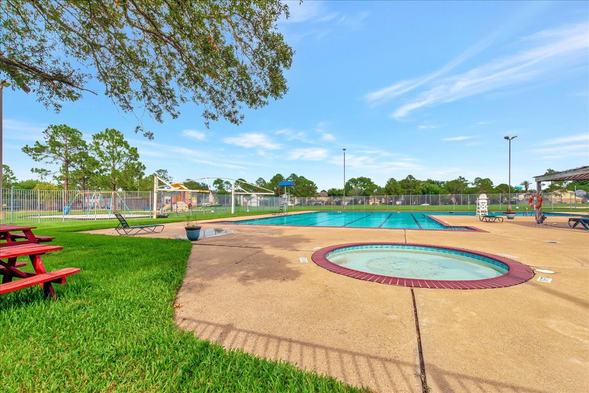 15131 Cranbourne Drive Houston, TX 77062 - Photo 40 of 42 a view of a swimming pool with a yard and trees