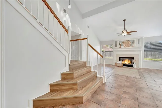 a view of entryway and hall with a fireplace