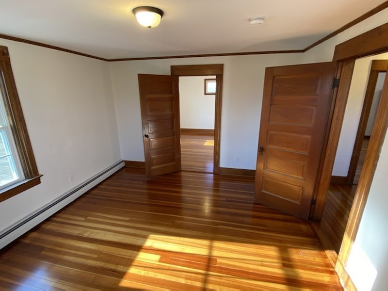 82 Comins Road, Unit 2 Hadley, MA 01035 - Photo 11 of 12 a view of empty room with wooden floor