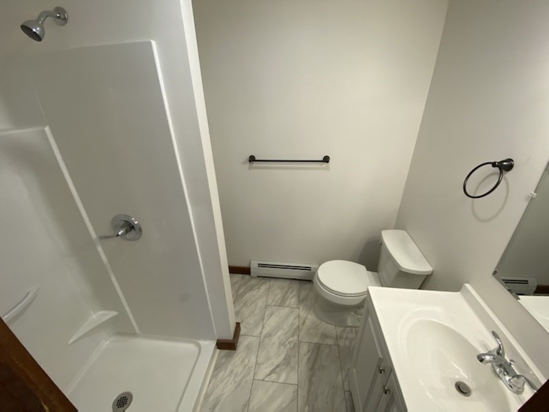 82 Comins Road, Unit 2 Hadley, MA 01035 - Photo 5 of 12 a bathroom with a granite countertop sink toilet and shower