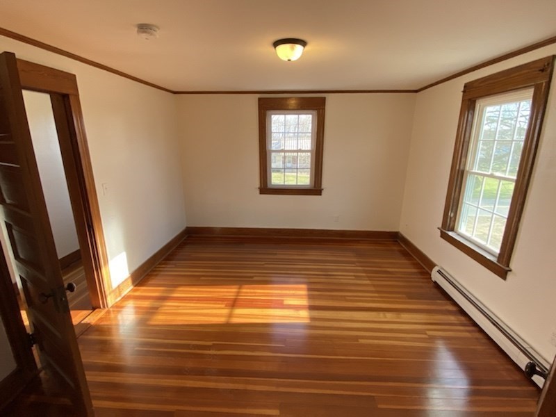 82 Comins Road, Unit 2 Hadley, MA 01035 - Photo 10 of 12 a view of empty room with wooden floor and fan