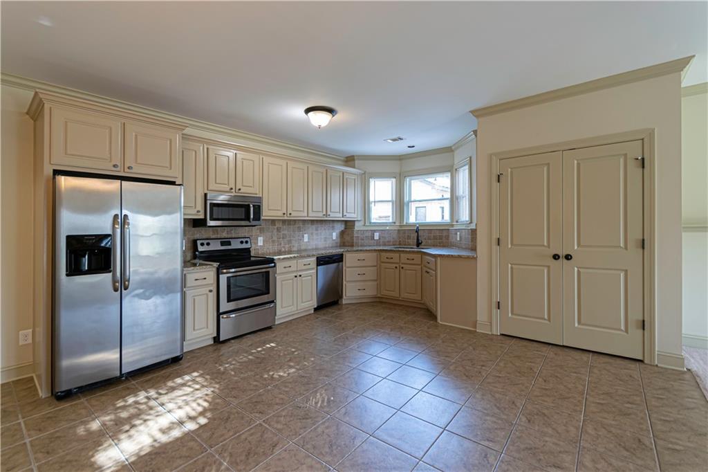 2050 Oak Grove Road Northeast Atlanta, GA 30345 - Photo 2 of 12 a kitchen with cabinets stainless steel appliances and a window