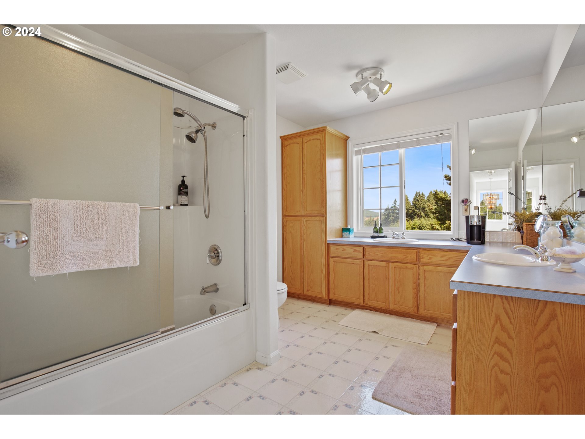 25059 Larson Road Monroe, OR 97456 - Photo 27 of 38 a bathroom with a granite countertop sink a mirror a bathtub and shower