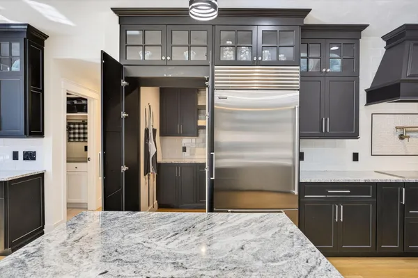 a kitchen with stainless steel appliances granite countertop a refrigerator and a sink