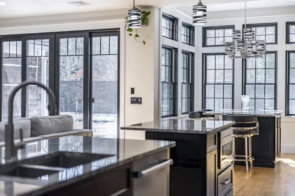 a kitchen with granite countertop a sink a stove and cabinets