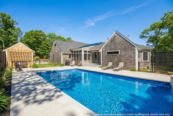 a view of house with swimming pool and porch
