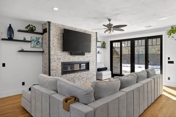 a living room with furniture fireplace and flat screen tv