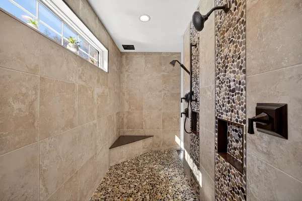a white bath tub sitting in a en suite bathroom