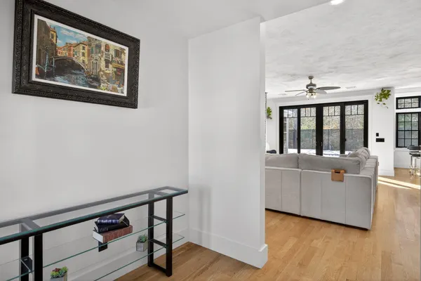 a living room with furniture and wooden floor