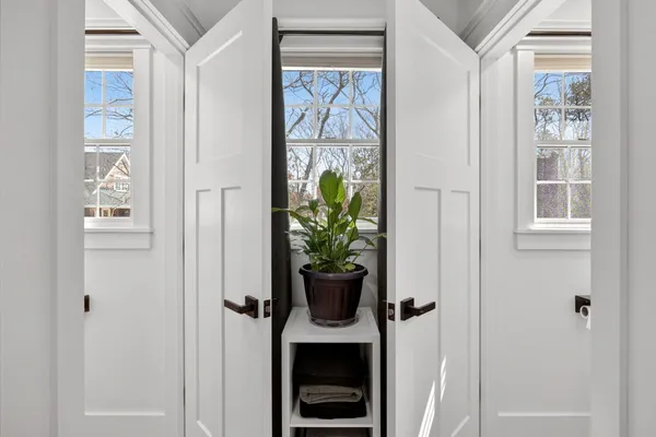 a bathroom with a sink a mirror and a window