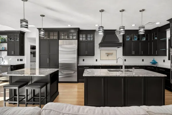 a kitchen with stainless steel appliances kitchen island granite countertop a cabinets and a view of living room