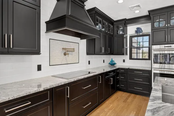 a kitchen with granite countertop a sink and cabinets