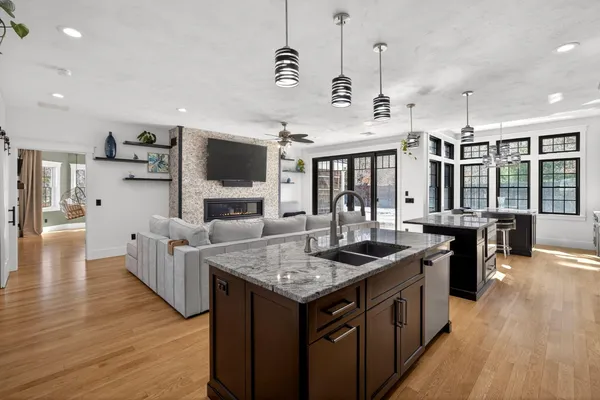 a kitchen with granite countertop a sink a counter top space and stainless steel appliances