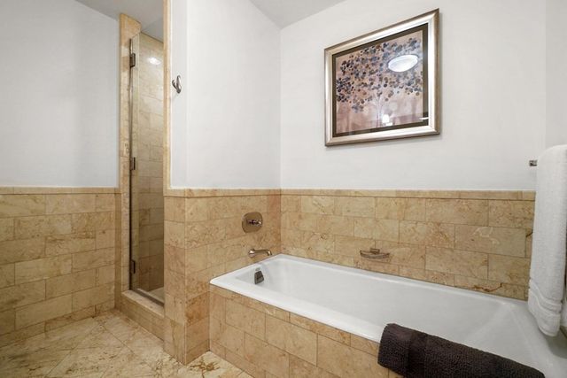 a bathroom with a granite countertop sink mirror and toilet